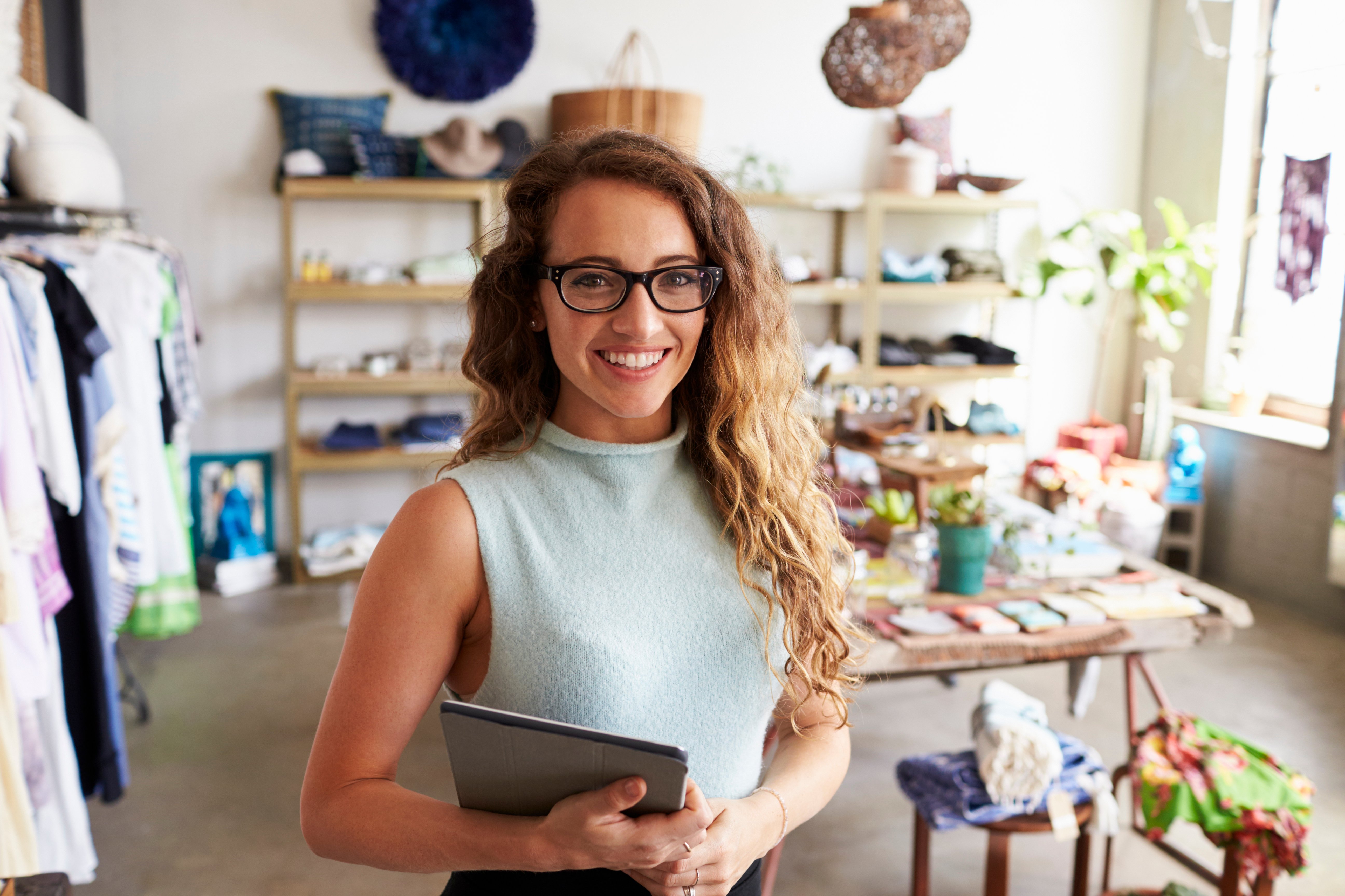 female-business-owner-holding-tablet-computer-in-PEVERD4